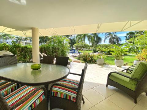 Palm Beach 211 Barbados Beachfront Vacation Condo Rental Covered Patio with Dining and Lounge Seating