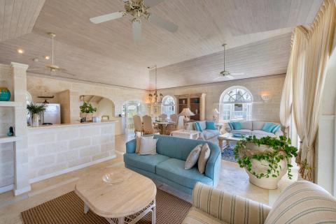 Spacious and elegantly furnished living room at Forest Hills 23 in Royal Westmoreland, Barbados, featuring plush seating, high ceilings, and natural stone accents.