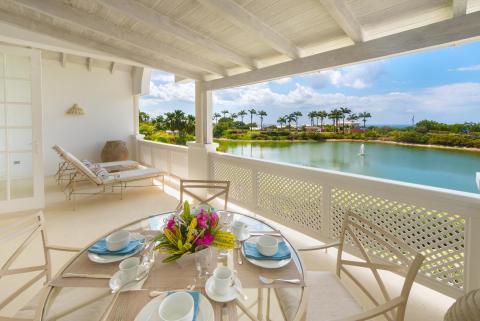Spacious outdoor patio at Forest Hills 23 in Royal Westmoreland, offering breathtaking views of the pond, tropical gardens, and the Caribbean Sea.