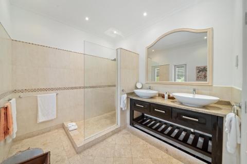 Contemporary bathroom with a spacious shower, dual vanities, and modern design at Ixora, Royal Westmoreland, Barbados