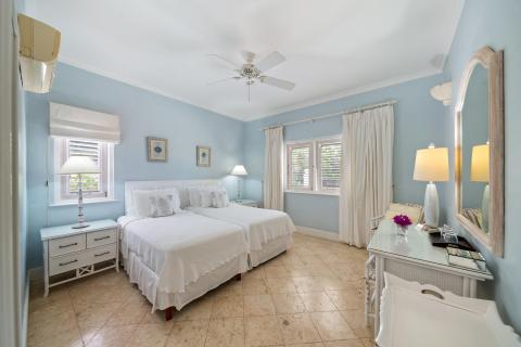 Cozy bedroom with two twin beds, tasteful décor, and ample natural light at Ixora, Royal Westmoreland, Barbados