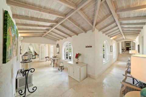Charming walkway with lush tropical greenery, leading to a private outdoor sitting area at Ixora, Royal Westmoreland, Barbados