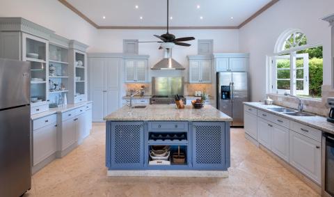 Fully-equipped kitchen with sleek cabinets, modern appliances, and a spacious island at Ixora, Royal Westmoreland, Barbados