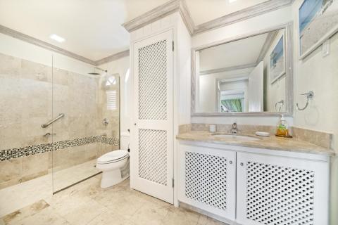 Spacious second bathroom in Sunshine View Penthouse, Sugar Hill Resort, Barbados, featuring a large walk-in shower, marble countertops, and stylish tile accents, combining luxury with convenience for a relaxing experience.