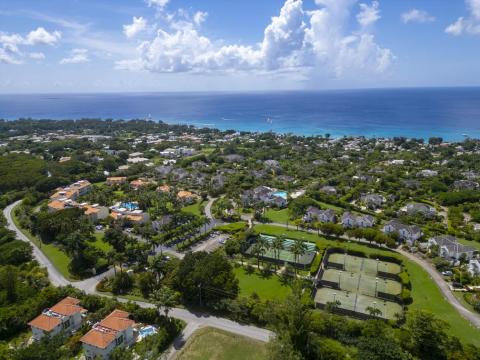 Another high-angle view over Sugar Hill Resort, showcasing the exclusive amenities including multiple tennis courts, expansive green spaces, and proximity to Barbados’ scenic coastline, ideal for a relaxing stay.