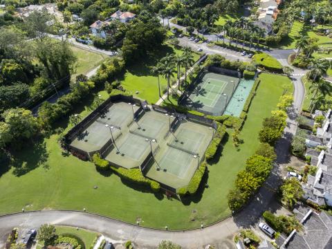 Sugar Hill Resort tennis courts in Barbados, surrounded by manicured lawns and tropical gardens, offering guests at Seabreeze Penthouse ample recreational facilities within the resort’s peaceful environment.