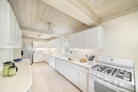 A fully equipped kitchen at Seascape villa in Barbados, showcasing a bright and functional space for preparing meals during a beachfront vacation rental.