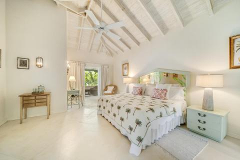 Image of a charming bedroom with garden views at Seascape, Barbados: A serene and inviting bedroom designed for comfort, with elegant furniture, soft lighting, and garden views, offering a perfect escape in this luxury Barbados villa rental.