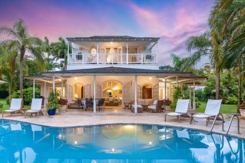 Villa Rosa Holiday Rental Villa In Royal Westmoreland Barbados Sunset Shot of Pool Deck and House with Lights On